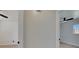 Hallway leading to adjacent bedrooms, featuring light hardwood flooring and modern ceiling fans at 564 Florida S Cir, Apollo Beach, FL 33572