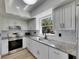 Updated kitchen featuring granite countertops and modern fixtures at 564 Florida S Cir, Apollo Beach, FL 33572