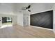 Bright, open-concept living room featuring hardwood floors and a modern accent wall at 564 Florida S Cir, Apollo Beach, FL 33572