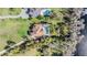 Aerial view of waterfront homes surrounded by lush greenery and the sparkling blue lake at 5914 Fitzgerald Rd, Odessa, FL 33556