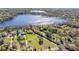 Stunning aerial view of lakeside homes featuring lush landscaping and mature trees at 5914 Fitzgerald Rd, Odessa, FL 33556