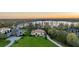 Stunning aerial view of a lakeside home with lush green lawn, mature trees, and a beautiful water view at 5914 Fitzgerald Rd, Odessa, FL 33556