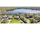 Aerial view of waterfront homes surrounded by lush greenery and the sparkling blue lake at 5914 Fitzgerald Rd, Odessa, FL 33556