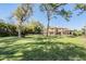 Spacious backyard with lush lawn, mature trees, and a rod iron fence surrounding the property at 5914 Fitzgerald Rd, Odessa, FL 33556