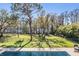 Beautiful backyard featuring lush landscaping, a fenced-in yard, mature trees, and an inviting pool at 5914 Fitzgerald Rd, Odessa, FL 33556