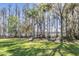 Lush backyard with mature trees and a lake view with a wooden dock at 5914 Fitzgerald Rd, Odessa, FL 33556