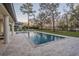 Beautiful backyard pool with lush landscaping and a tranquil view of the surrounding nature at 5914 Fitzgerald Rd, Odessa, FL 33556