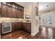 Stylish bar area featuring dark wood cabinetry, a wine cooler, and granite countertops at 5914 Fitzgerald Rd, Odessa, FL 33556