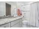 Bright bathroom features a shower-tub combo and granite countertop vanity with ample storage at 5914 Fitzgerald Rd, Odessa, FL 33556
