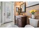 Well-lit bathroom with vanity, granite countertops, tiled accent wall, and modern fixtures at 5914 Fitzgerald Rd, Odessa, FL 33556