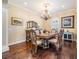 Formal dining room with hardwood flooring, a chandelier, and tasteful decor at 5914 Fitzgerald Rd, Odessa, FL 33556