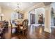 Formal dining room with hardwood flooring, a chandelier, and staircase access at 5914 Fitzgerald Rd, Odessa, FL 33556