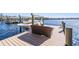 Dock with boat lift and outdoor seating on the lake, perfect for relaxing and enjoying the waterfront at 5914 Fitzgerald Rd, Odessa, FL 33556