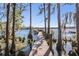 Picture of a wooden dock, featuring a boat lift, surrounded by trees and tranquil waters at 5914 Fitzgerald Rd, Odessa, FL 33556