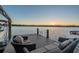 Relaxing lake view from a private dock with comfortable outdoor seating at sunset at 5914 Fitzgerald Rd, Odessa, FL 33556