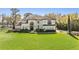 Elegant two-story home featuring a tile roof, manicured landscaping, and arched entryway at 5914 Fitzgerald Rd, Odessa, FL 33556
