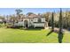 Elegant two-story home featuring a tile roof, manicured landscaping, and arched entryway at 5914 Fitzgerald Rd, Odessa, FL 33556