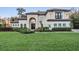 Beautiful home with manicured lawn, mature landscaping, and grand architectural details at 5914 Fitzgerald Rd, Odessa, FL 33556