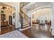 Spacious home interior with elegant wood floors, a staircase, and a view into the living area at 5914 Fitzgerald Rd, Odessa, FL 33556