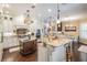Open kitchen layout with granite countertops, an island, and stainless steel appliances at 5914 Fitzgerald Rd, Odessa, FL 33556