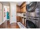 Convenient laundry area with wood cabinets, modern washer, dryer, and tile flooring at 5914 Fitzgerald Rd, Odessa, FL 33556