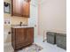 Functional laundry room with granite counters, storage cabinets, sink, and neutral tile flooring at 5914 Fitzgerald Rd, Odessa, FL 33556