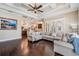 Bright living room showcasing hardwood floors, a large sectional sofa, and an open view to the kitchen at 5914 Fitzgerald Rd, Odessa, FL 33556