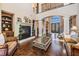 Elegant living room with a fireplace, dark hardwood floors, and a soaring two-story entrance at 5914 Fitzgerald Rd, Odessa, FL 33556