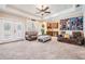 Spacious living room with wet bar, comfortable seating, recessed lighting, and large windows at 5914 Fitzgerald Rd, Odessa, FL 33556