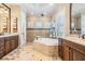 Elegant main bathroom showcasing a soaking tub, dual vanities, and a walk-in shower at 5914 Fitzgerald Rd, Odessa, FL 33556