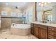 Beautiful main bathroom featuring a soaking tub, dual vanities, and ample counter space at 5914 Fitzgerald Rd, Odessa, FL 33556