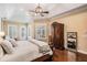 Bright main bedroom with hardwood floors, a comfortable bed, and ample storage space at 5914 Fitzgerald Rd, Odessa, FL 33556