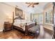 Luxurious main bedroom with hardwood floors, a canopy bed, and access to the outdoors at 5914 Fitzgerald Rd, Odessa, FL 33556