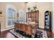 Stylish home office with a large desk, built-in bookshelves, and bright windows at 5914 Fitzgerald Rd, Odessa, FL 33556