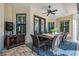 Outdoor dining area with a large wooden table, seating for eight, and stylish outdoor decor at 5914 Fitzgerald Rd, Odessa, FL 33556