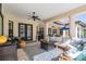 Inviting outdoor living space features a cozy seating area with a stylish area rug and a ceiling fan at 5914 Fitzgerald Rd, Odessa, FL 33556