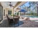 Expansive outdoor living space with a dining area, seating, and pool, perfect for entertaining at 5914 Fitzgerald Rd, Odessa, FL 33556
