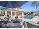 Luxurious outdoor patio with comfortable seating, dining area and a beautiful pool view at 5914 Fitzgerald Rd, Odessa, FL 33556