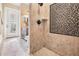 Walk-in shower featuring neutral tile, glass door, and adjacent powder room at 5914 Fitzgerald Rd, Odessa, FL 33556