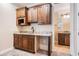 This wet bar includes beautiful custom cabinetry with granite countertops and a stainless steel sink at 5914 Fitzgerald Rd, Odessa, FL 33556