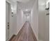 Clean, well-lit hallway with wood flooring and modern sconces, leading to various unit entrances at 600 3Rd S Ave # 207, St Petersburg, FL 33701