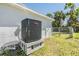 New HVAC system with a Goodman unit located outside the house on a concrete platform at 6214 Westport Dr, Port Richey, FL 34668