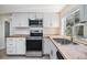 Modern kitchen with butcher block countertops, stainless steel appliances, and white cabinetry at 6214 Westport Dr, Port Richey, FL 34668