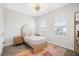 Bright bedroom with wood floors, modern lighting, and plantation shutters offers a cozy and stylish space at 7122 Bowspirit Pl, Apollo Beach, FL 33572