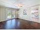 Living room featuring wood floors, a ceiling fan, and access to the kitchen and backyard at 7211 10Th N Ave, St Petersburg, FL 33710