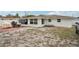 The backyard features a red brick patio, covered boat, and a partially fenced perimeter at 7740 Bracken Dr, Port Richey, FL 34668