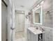 Contemporary bathroom showcasing a vanity with unique storage and a stylish backlit mirror at 7740 Bracken Dr, Port Richey, FL 34668