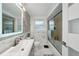 Well-lit bathroom featuring a large sink, shower with sliding glass doors, and a clean, modern design at 7740 Bracken Dr, Port Richey, FL 34668