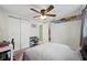 This bedroom features a ceiling fan, closet, and quirky license plate decorations at 7740 Bracken Dr, Port Richey, FL 34668