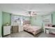 Cozy bedroom with a ceiling fan, and ample natural light with neutral color palette at 7740 Bracken Dr, Port Richey, FL 34668